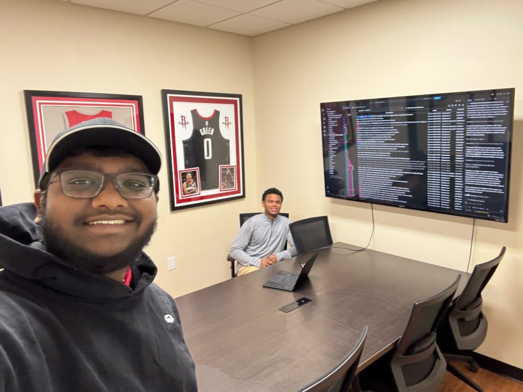 Two interns in the conference room during a working session